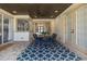 The covered back patio showcases tile flooring and an outdoor dining table with seating at 10645 Garda Dr, Trinity, FL 34655