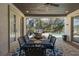 Covered patio featuring tile flooring, ceiling fan, and outdoor dining table and chairs at 10645 Garda Dr, Trinity, FL 34655