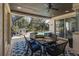 Inviting outdoor patio with seating area overlooking a screened pool and lush backyard, perfect for relaxation at 10645 Garda Dr, Trinity, FL 34655