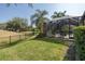 Enclosed pool and patio area overlooking a well-manicured lawn and a scenic golf course at 10645 Garda Dr, Trinity, FL 34655