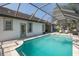 A lovely pool with screen enclosure, tile border, and connected to the home's exterior at 10645 Garda Dr, Trinity, FL 34655