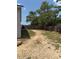 A spacious backyard featuring mature trees, bordered by a wooden fence, offers a peaceful and private outdoor setting at 11080 Jackdaw Rd, Weeki Wachee, FL 34614