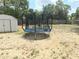 Expansive backyard offers a trampoline for recreation, complemented by a shed for outdoor storage, with privacy fencing at 11080 Jackdaw Rd, Weeki Wachee, FL 34614