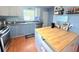 Kitchen featuring updated appliances, butcher block island, and laminate floors at 11080 Jackdaw Rd, Weeki Wachee, FL 34614