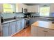Kitchen featuring updated appliances and cabinetry with laminate floors at 11080 Jackdaw Rd, Weeki Wachee, FL 34614