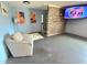 Cozy living room with exposed brick wall and tv at 11080 Jackdaw Rd, Weeki Wachee, FL 34614