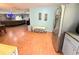 Open-concept living room featuring hardwood floors and easy access to dining and stainless steel appliances at 11080 Jackdaw Rd, Weeki Wachee, FL 34614