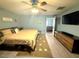 Spacious primary bedroom with ceiling fan at 11080 Jackdaw Rd, Weeki Wachee, FL 34614