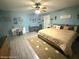 This bedroom features a ceiling fan, and lots of pictures at 11080 Jackdaw Rd, Weeki Wachee, FL 34614