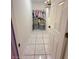 A tidy walk-in closet with neatly arranged clothes and accessories offers efficient storage with stylish tile flooring at 11080 Jackdaw Rd, Weeki Wachee, FL 34614