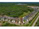 Aerial view of the property showcasing its location near wooded areas and other residential homes at 11401 Quiet Forest Dr, Tampa, FL 33635