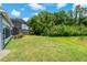 Lush backyard featuring a well-manicured lawn and partial view of a screened in pool area at 11401 Quiet Forest Dr, Tampa, FL 33635