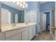 Bright bathroom with double vanity sinks, large mirror, and a separate glass-enclosed shower at 11401 Quiet Forest Dr, Tampa, FL 33635