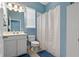 Clean bathroom with vanity sink, toilet, and shower featuring a white shower curtain at 11401 Quiet Forest Dr, Tampa, FL 33635