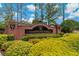 Community entrance sign with brick columns, manicured landscaping, and clear Champions Forest signage at 11401 Quiet Forest Dr, Tampa, FL 33635
