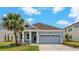 Charming single-story home with a well-manicured lawn and a welcoming two-car garage at 11401 Quiet Forest Dr, Tampa, FL 33635