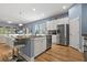 Open kitchen with a large island, stainless steel appliances, and views of the dining and living areas at 11401 Quiet Forest Dr, Tampa, FL 33635