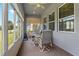 Relaxing sunroom with plenty of natural light, a ceiling fan and a table with swivel chairs at 11401 Quiet Forest Dr, Tampa, FL 33635