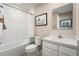 Clean bathroom with white fixtures, tiled walls, and decorative touches creating a fresh and functional space at 11410 Spectacled Dr, New Port Richey, FL 34654