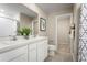 Bright bathroom featuring double sinks, white cabinetry, and modern fixtures providing a functional space at 11410 Spectacled Dr, New Port Richey, FL 34654