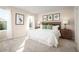 Spacious bedroom with a king-size bed, stylish artwork, and ample natural light creating a peaceful ambiance at 11410 Spectacled Dr, New Port Richey, FL 34654