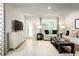 Inviting living room with neutral tones, stylish decor, and natural light creating a cozy and modern space at 11410 Spectacled Dr, New Port Richey, FL 34654