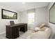 Serene office space with a classic wooden desk, comfortable seating, and natural light promoting a productive environment at 11410 Spectacled Dr, New Port Richey, FL 34654