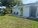 Backyard view with patio, chairs, and table, offering a relaxing outdoor space at 11631 Bayonet Ln, New Port Richey, FL 34654
