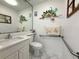 Well-lit bathroom with a modern vanity, mirror, and stylish decorations at 11631 Bayonet Ln, New Port Richey, FL 34654