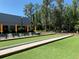 View of community bocce ball court with seating and shade umbrellas at 11631 Bayonet Ln, New Port Richey, FL 34654