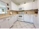 Efficient kitchen with white cabinets, modern appliances, and ample counter space at 11631 Bayonet Ln, New Port Richey, FL 34654