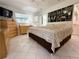 Serene bedroom with tiled floors, natural lighting, and decorative wall art at 11631 Bayonet Ln, New Port Richey, FL 34654
