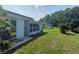 Spacious backyard with lush green lawn, additional building, and picturesque landscaping at 11631 Bayonet Ln, New Port Richey, FL 34654