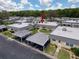 A community featuring multiple residences with carports and a lush green backdrop at 11821 Boynton Ln, New Port Richey, FL 34654