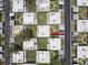 Overhead view of residential area with tidy landscaping, carports, and orderly street layout at 11821 Boynton Ln, New Port Richey, FL 34654