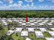 Wide aerial view of the condo community surrounded by lush green trees and landscaping at 11821 Boynton Ln, New Port Richey, FL 34654