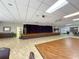 Auditorium features a stage, elegant drapes, ample seating, and full audio-visual capabilities at 11821 Boynton Ln, New Port Richey, FL 34654