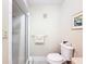 Bathroom featuring a toilet, walk-in shower with glass doors and a towel rack at 11821 Boynton Ln, New Port Richey, FL 34654