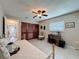 Bedroom with tile floors, ceiling fan, closet, and desk near window at 11821 Boynton Ln, New Port Richey, FL 34654
