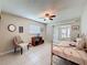 Bright bedroom features neutral-colored walls, a ceiling fan, and sliding doors to the lanai at 11821 Boynton Ln, New Port Richey, FL 34654