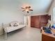 Cozy bedroom featuring a ceiling fan, tile flooring, and closet with wooden doors at 11821 Boynton Ln, New Port Richey, FL 34654