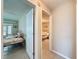 Bedroom showcases an open doorway and leads to a bedroom with neutral-colored walls and tile floors at 11821 Boynton Ln, New Port Richey, FL 34654