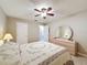 Cozy bedroom with neutral walls, tiled floor, and a dresser with a large oval mirror at 11821 Boynton Ln, New Port Richey, FL 34654