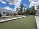 Outdoor bocce ball court area with benches and umbrella-shaded tables at 11821 Boynton Ln, New Port Richey, FL 34654