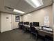View of computer room with computers, chairs, printer, carpet flooring and off-white painted walls at 11821 Boynton Ln, New Port Richey, FL 34654