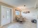 Cozy dining area featuring a round table, seating for four, and natural light from the front door at 11821 Boynton Ln, New Port Richey, FL 34654