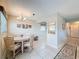 Cozy dining area with tile flooring, chandelier and view into the kitchen at 11821 Boynton Ln, New Port Richey, FL 34654