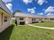 Inviting single-story home with a well-maintained lawn and metal roof at 11821 Boynton Ln, New Port Richey, FL 34654