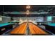 Bright game room featuring shuffleboard, pool tables, ping pong table, dark ceilings and carpet flooring at 11821 Boynton Ln, New Port Richey, FL 34654