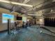Community gym featuring stationary bikes, weight machines, dark ceiling, and carpet flooring at 11821 Boynton Ln, New Port Richey, FL 34654